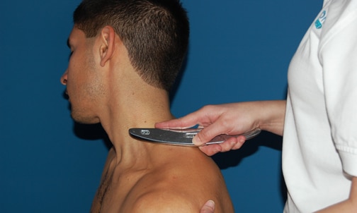 Graston Technique on a patient's neck and trap