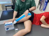 Kinesio Tape being applied to the hip